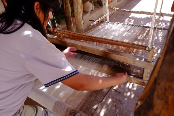 Local weavers using traditional methods with sheep and llama wool